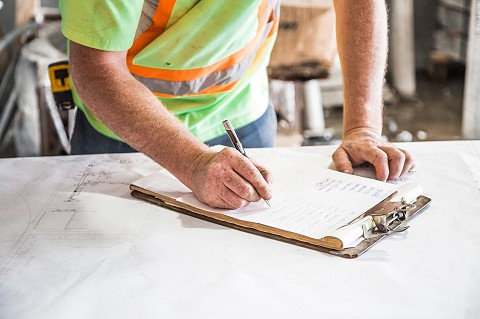 Construction worker using clipboard